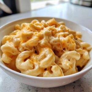 A bowl of creamy Instant Pot mac and cheese with melted cheddar, ready to eat.