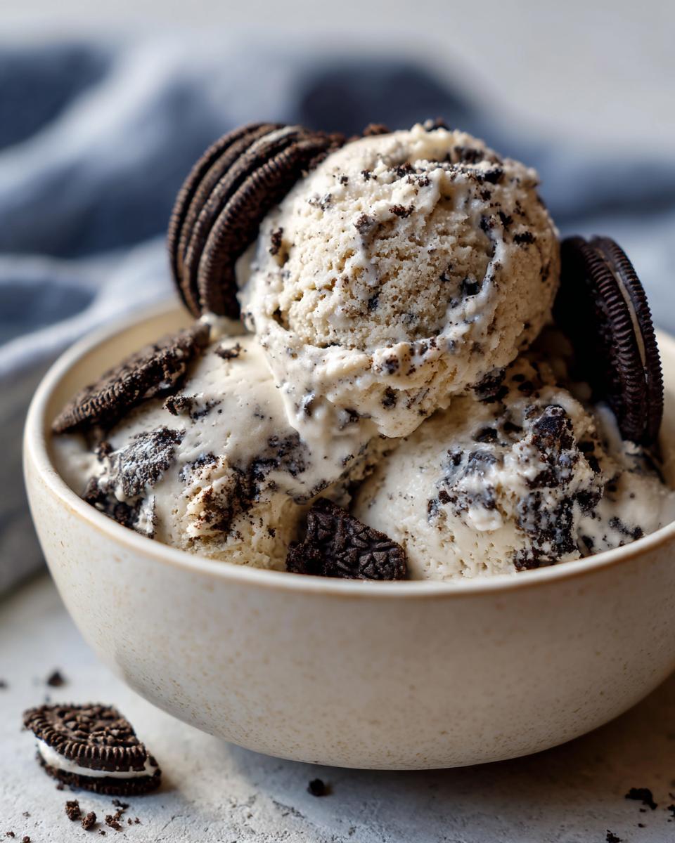 A bowl of creamy no-churn Oreo ice cream, topped with Oreo cookies for a delicious dessert.