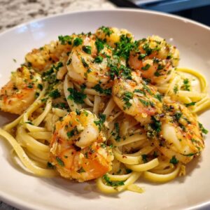 A plate of Shrimp Scampi with linguine, garnished with fresh parsley. Ready to eat!